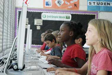 Teacher and students in a classroom technology setting